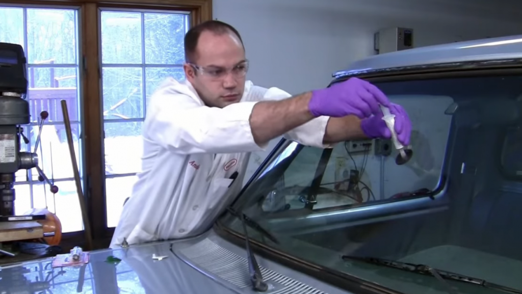 man using loctite windshield repair kit to fix damaged glass