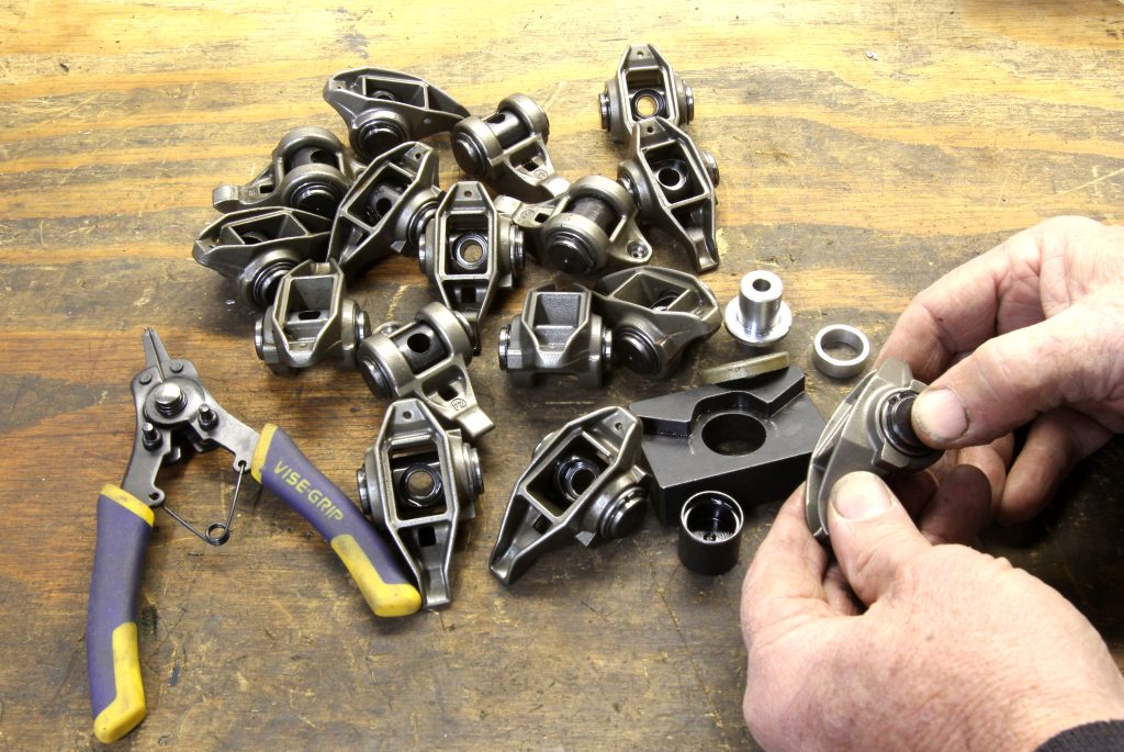 collection of rocker arms being assembled on workbench