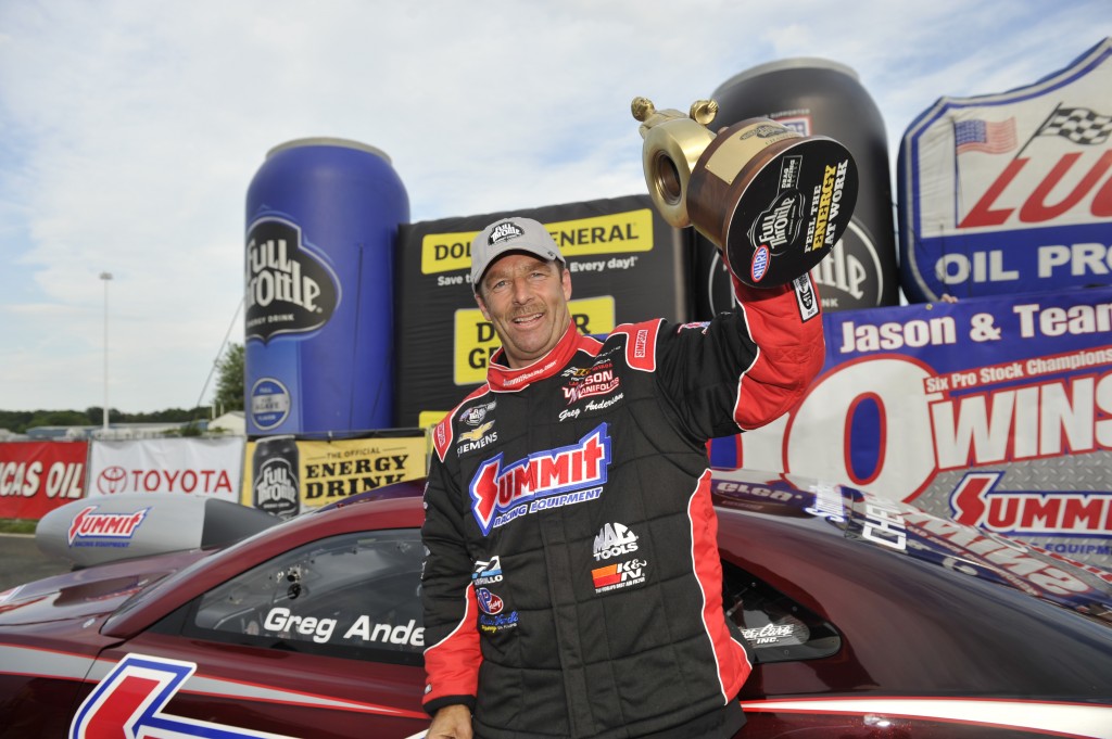 greg anderson holding wally trophy