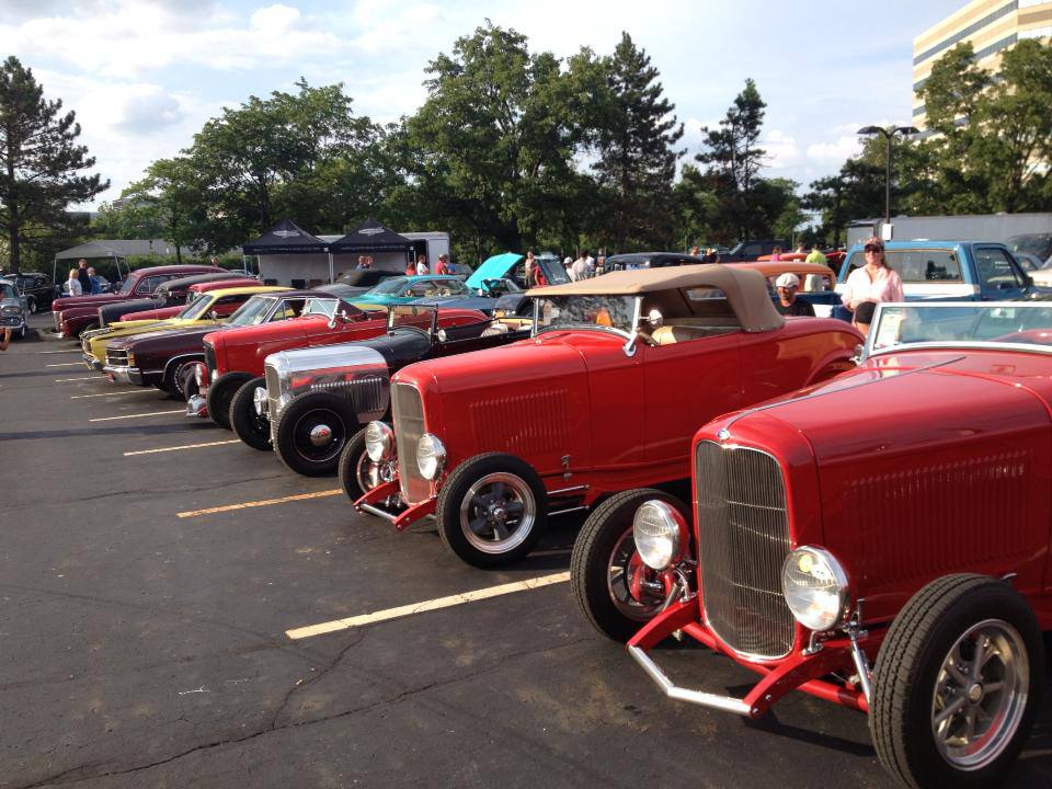 row of hot rods at a large show