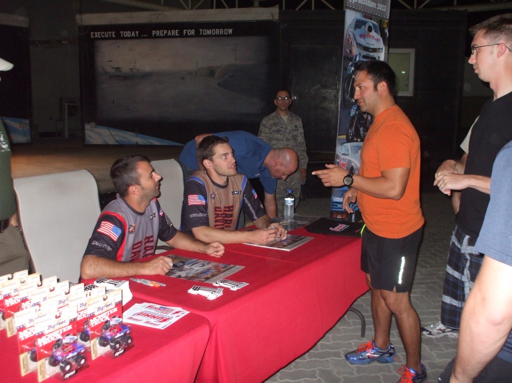 NHRA & Monster Truck Drivers signing autographs for troops stationed overseas