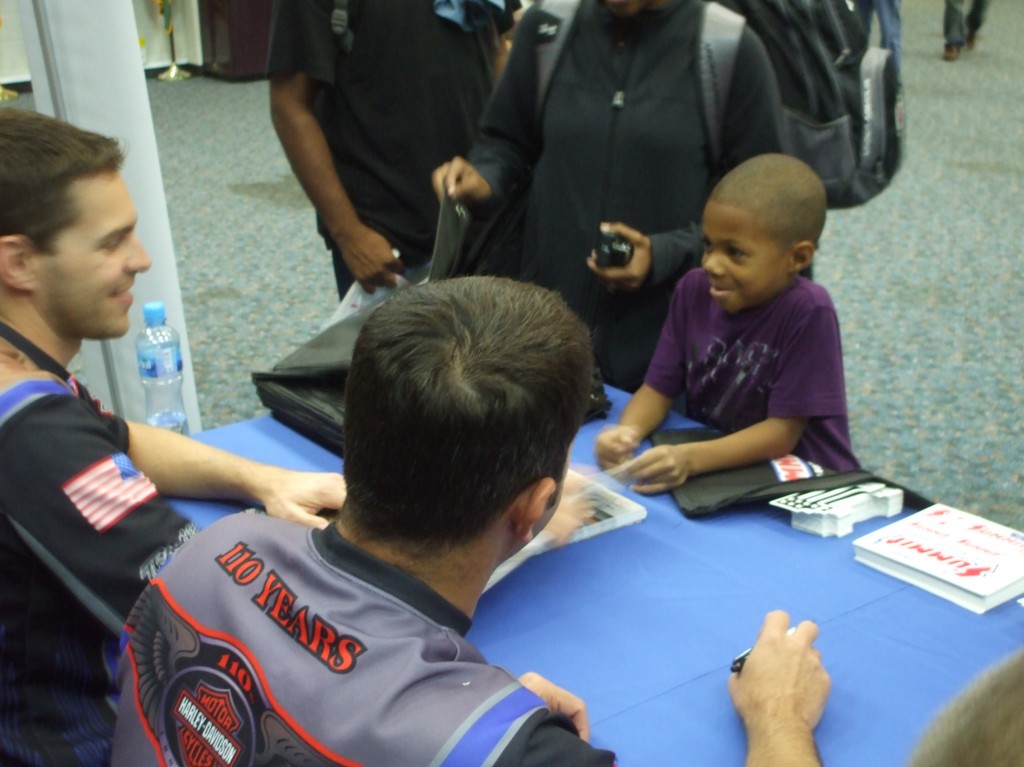 NHRA & Monster Truck Drivers signing autographs for troops stationed overseas