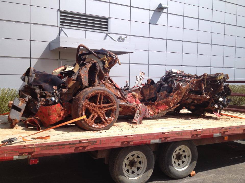 final corvette from sinkhole resting on a flatbed trailer