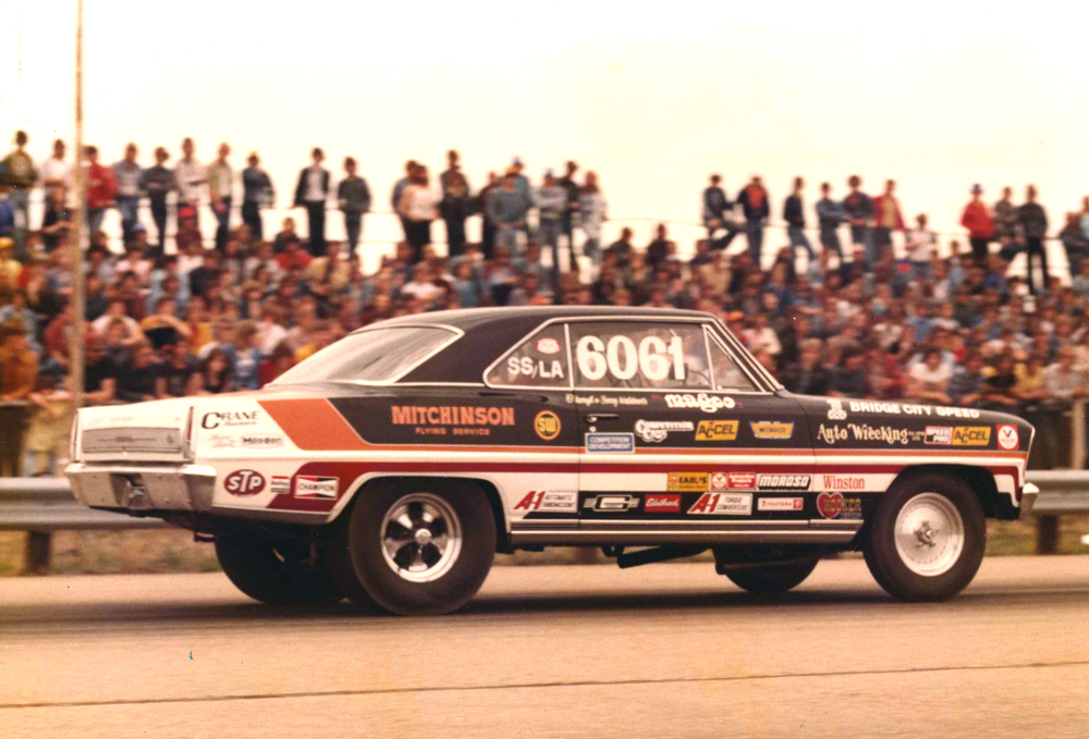 vintage photo of a chevy ii nova drag race car launching at dragstrip