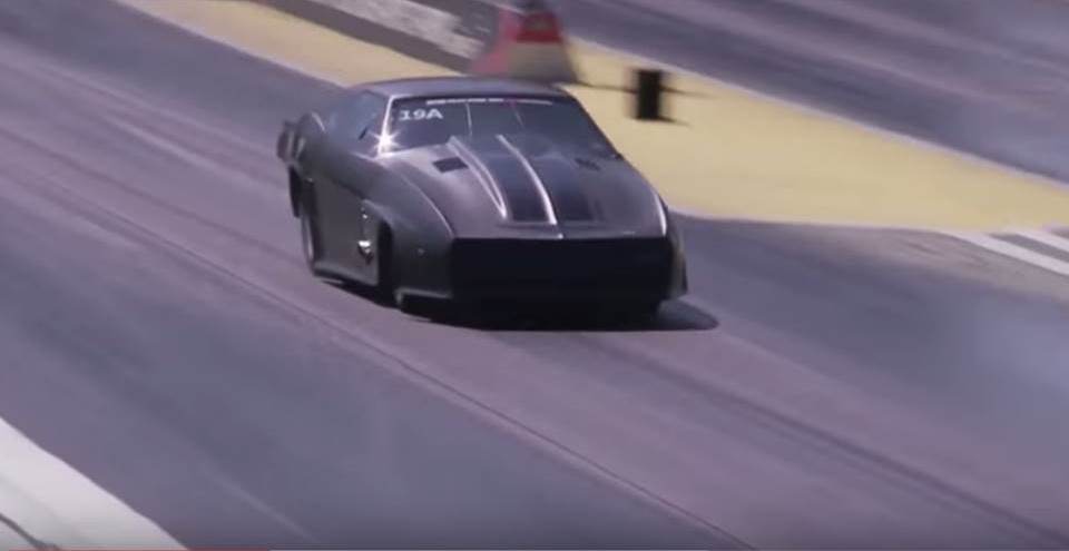 Jeff Lutz driving down a drag strip in a black camaro