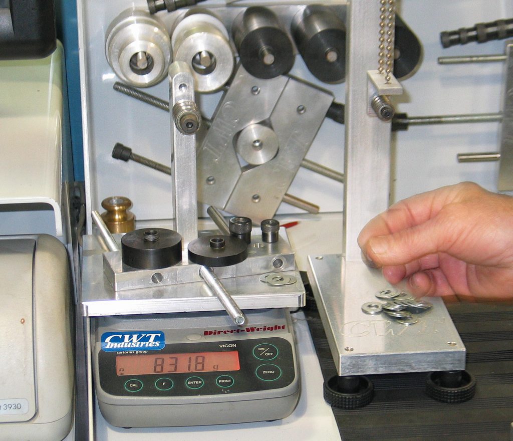 checking piston components weight on scale