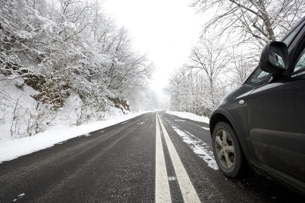 car driving on snowy winter road