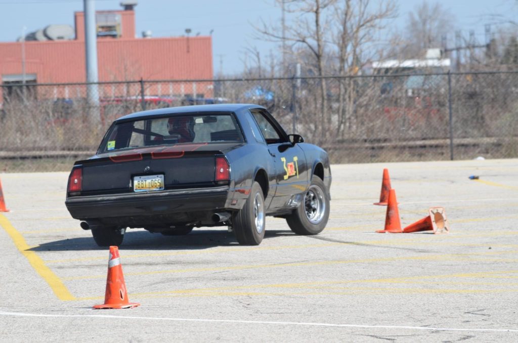 vintage chevy monte carlo ss weaving through cones on an autocross course