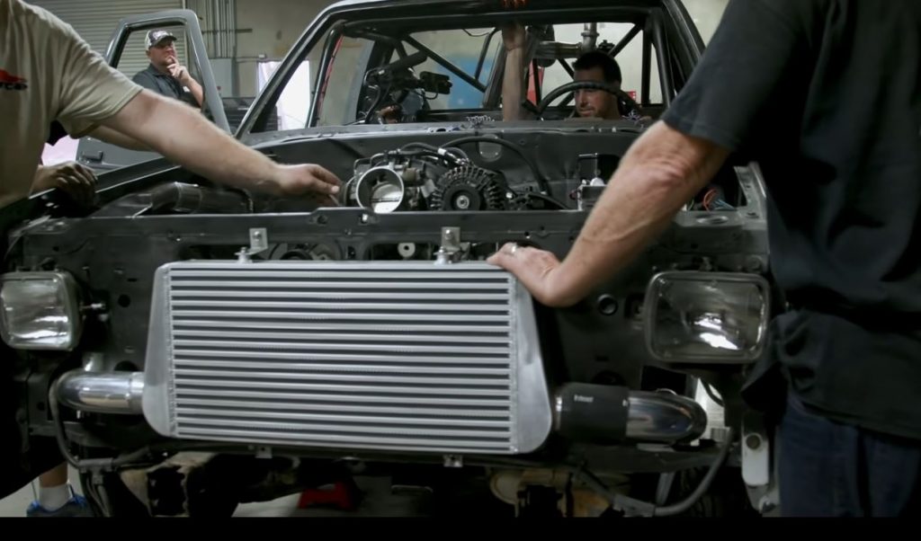 men installing intercooler into an s-10 drag race truck with an ls swap