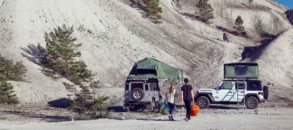 a group of overlanders in a desert campground scene