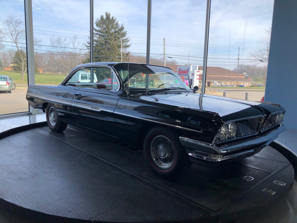 side uarter shot of a 1961 pontiac ventura on an indoor turntable