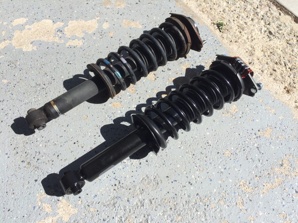 side by side comparison of old and new strut assemblies for a 2012 subaru outback