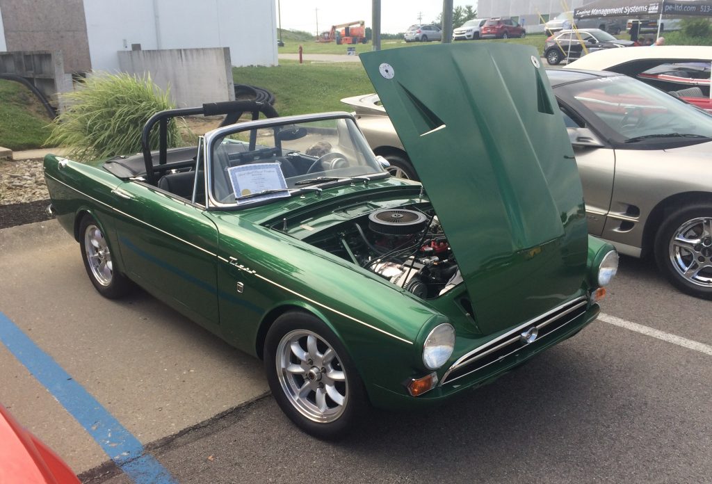 green sunbeam tiger at a vintage car show