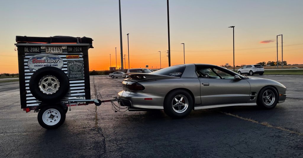 pontiac trans am pulling a race trailer for hot rod drag week