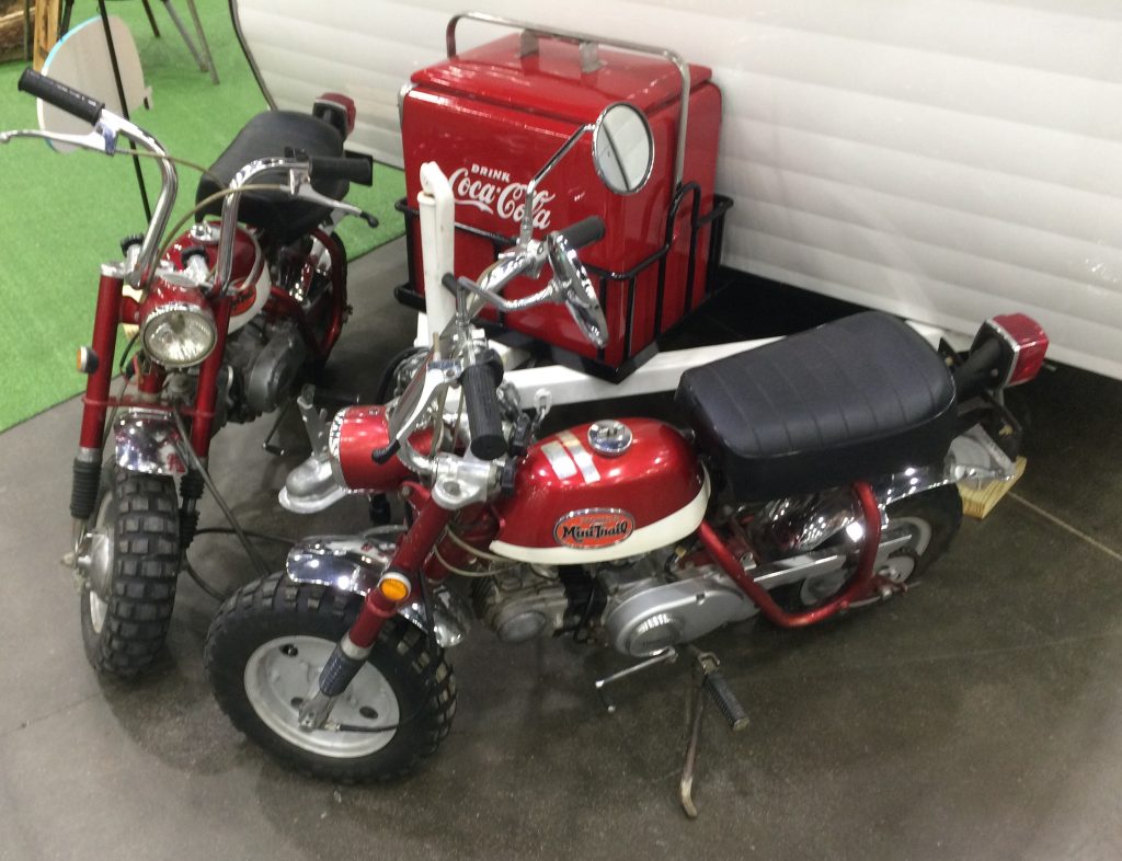 vintage honda minitrail motorcycles at indoor car show