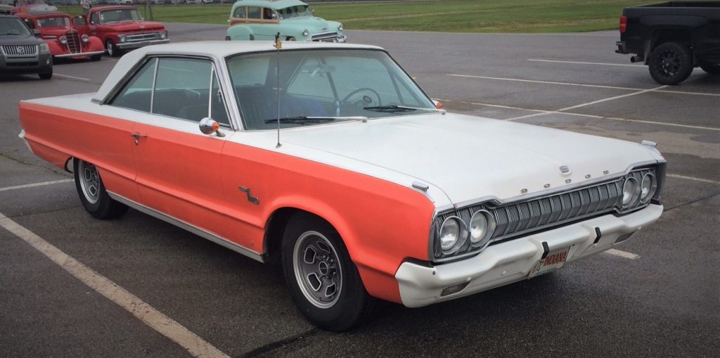 a white and orange dodge monaco coupe