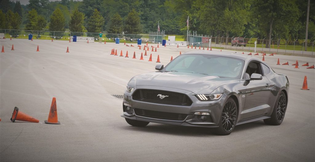 ford mustang sliding through cones during turn on autocross Couse