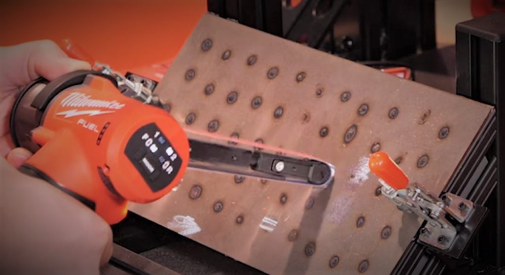 man using Milwaukee spot weld grinder in a demo