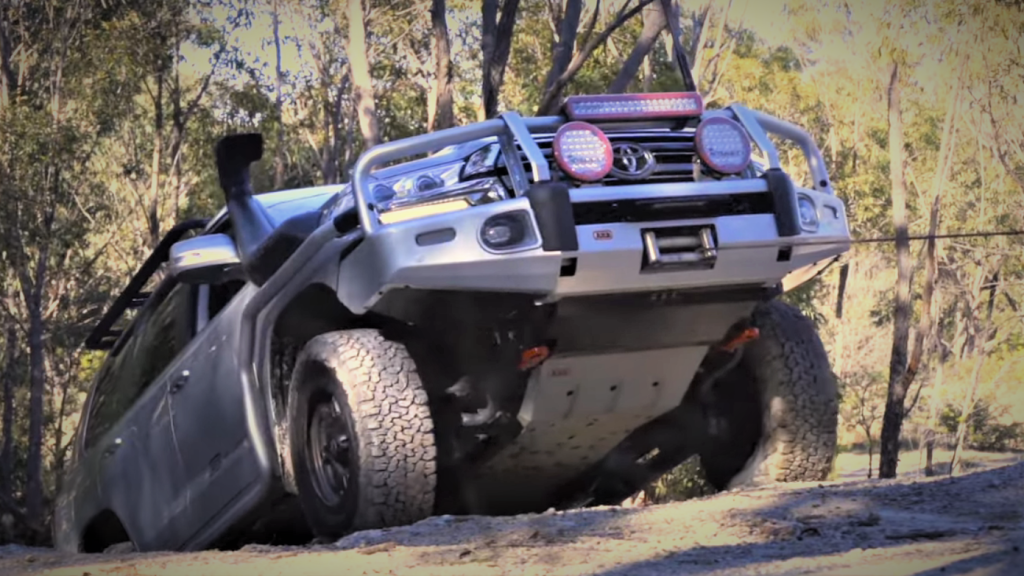 toyota off road land cruiser pulling up a hill with a winch