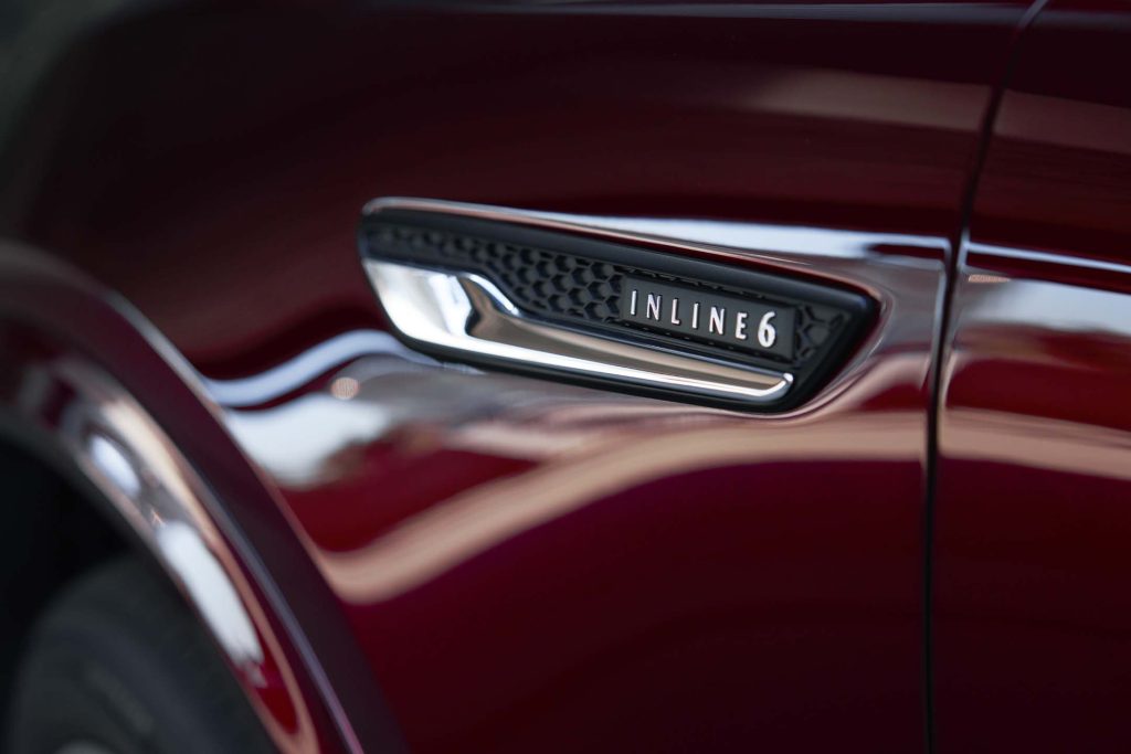 inline six badge on mazda fender