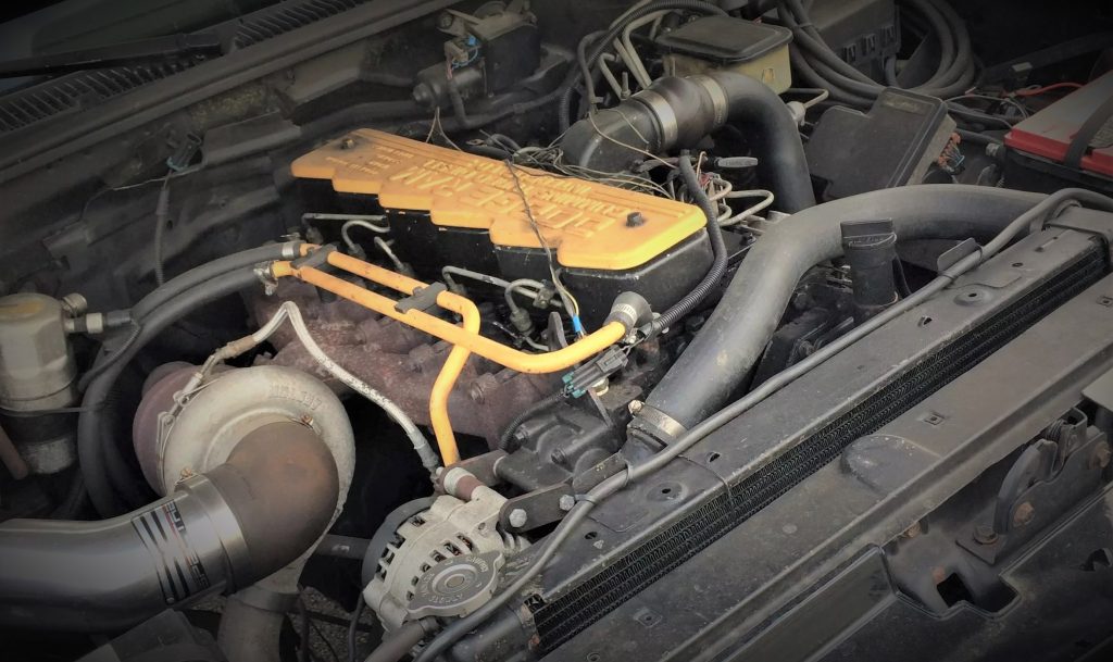 engine bay with cummins ram diesel engine in a gmc sierra pickup truck