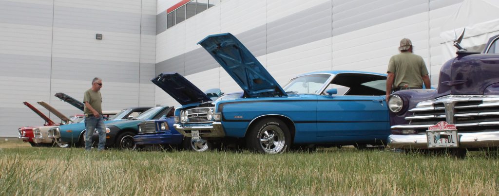 row of classic cars on display at summit racing store