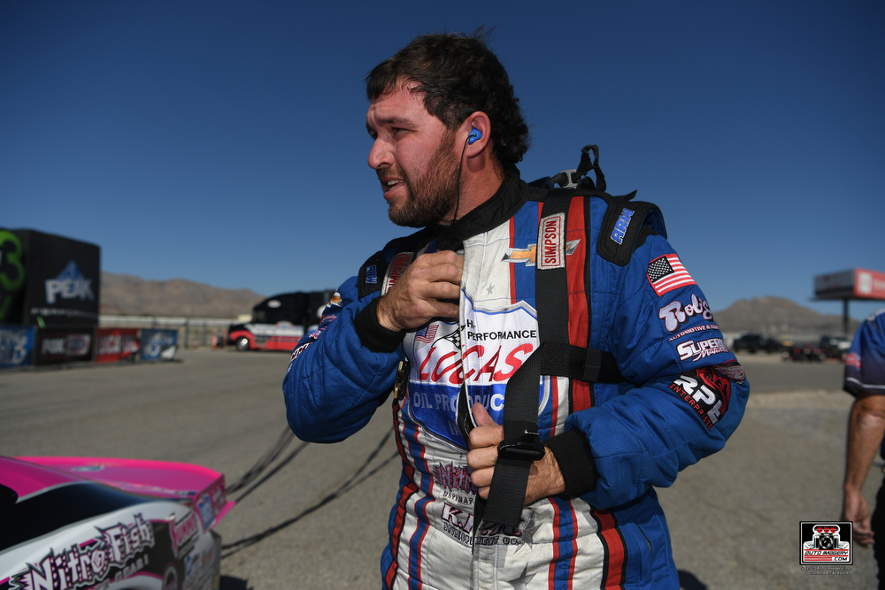 Kyle Koretsky unzipping race suit after race with hearing protection