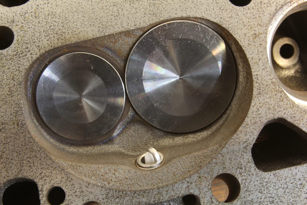 close up of spark plug tip inside a cylinder head combustion chamber