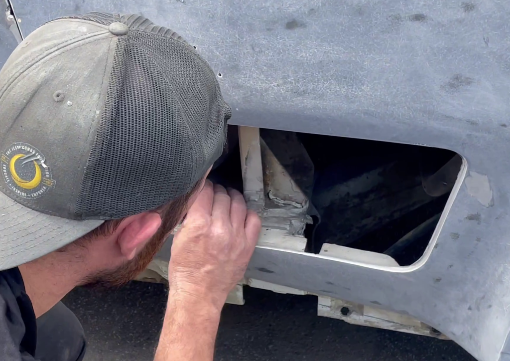 man repairing front fiberglass on a 1970 chevy corvette