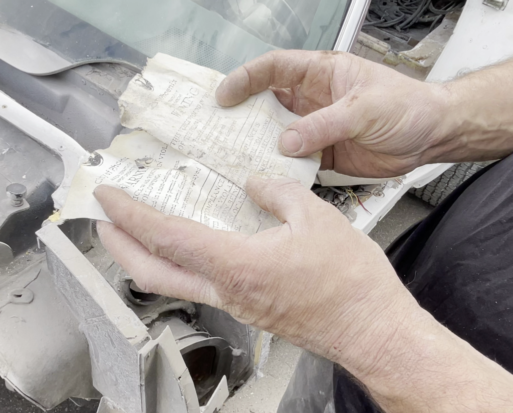 person holding vintage parking tickets found in an old car