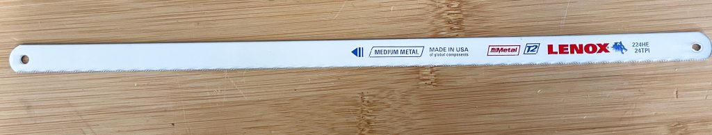hacksaw blade laying on workbench