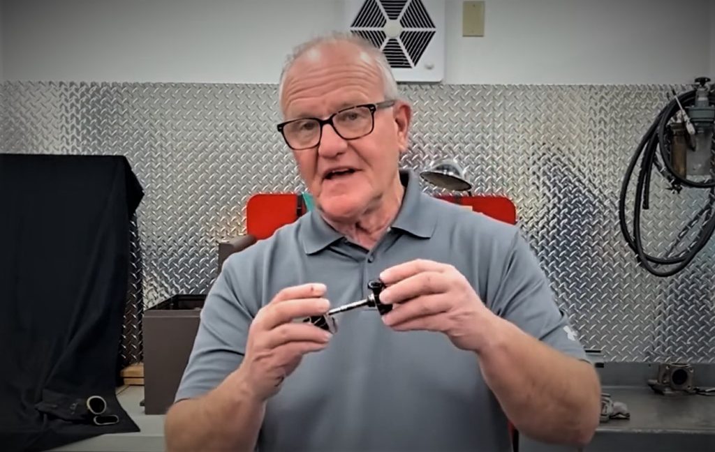 man holding a turbocharger impeller turbine