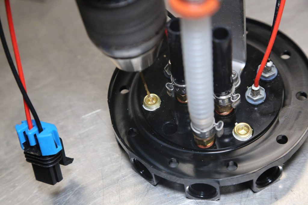 drilling a small pilot hole in a fuel tank bulkhead cap