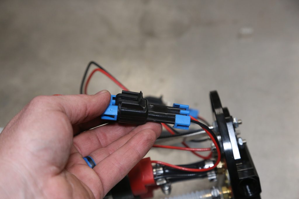 man holing an automotive electrical connector