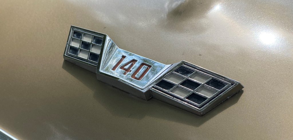 140 cubic inch engine emblem badge on a 1966 corvair