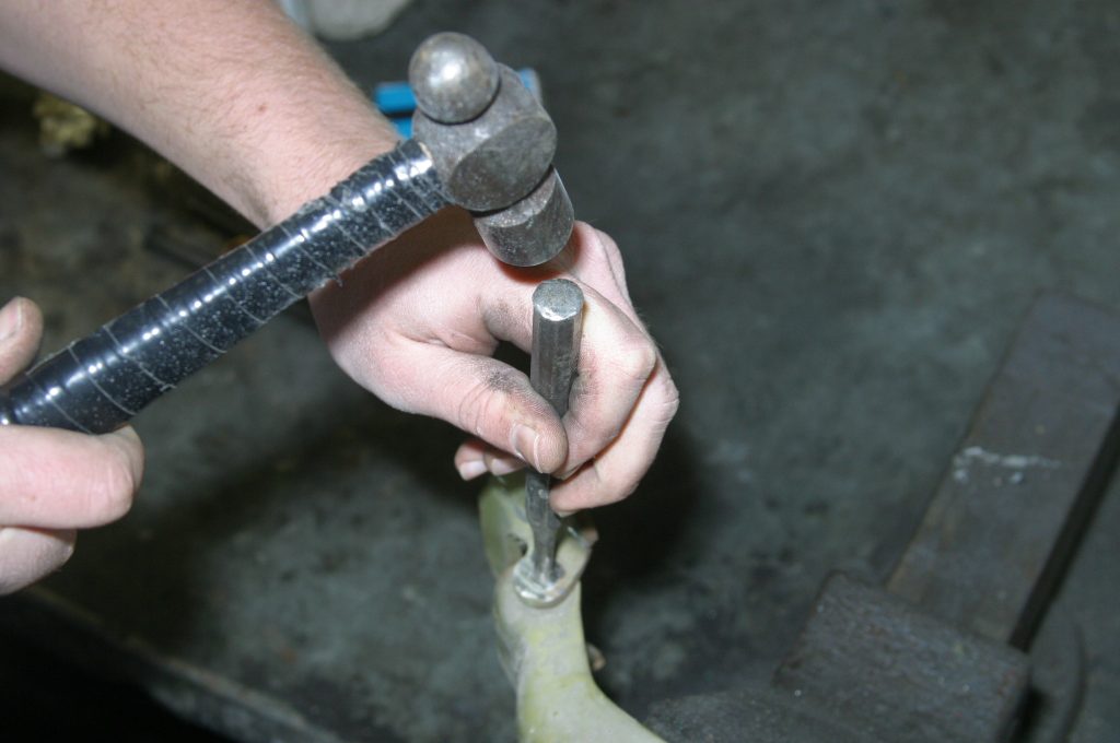 hammering out a car door hinge pin