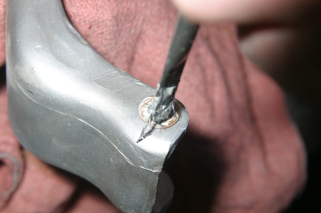 lubricating pin bushing in a car door hinge