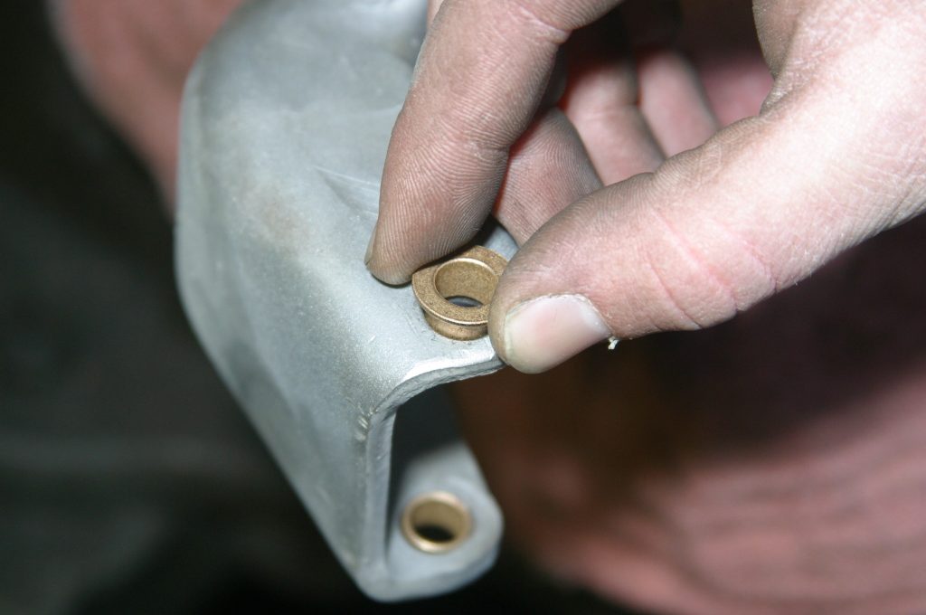 inserting a brass pin pushing into a car door hinge