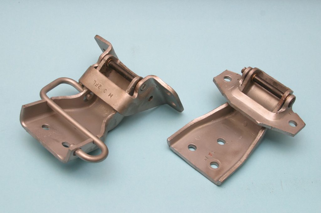 a pair of restored vintage car door hinges