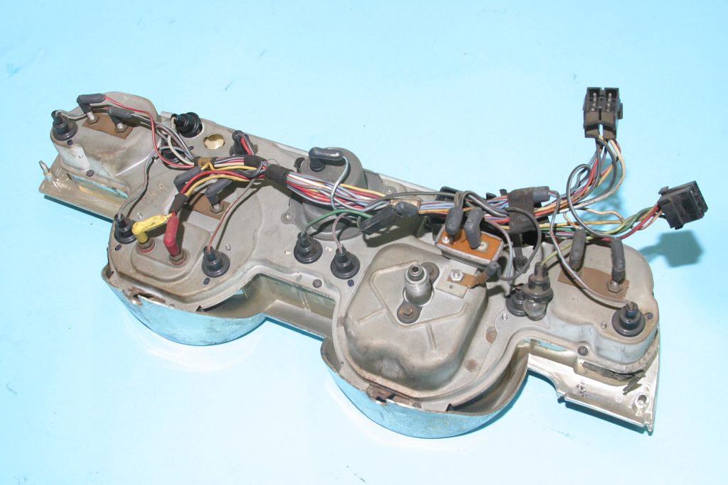 back of a vintage vehicle gauge cluster with wiring