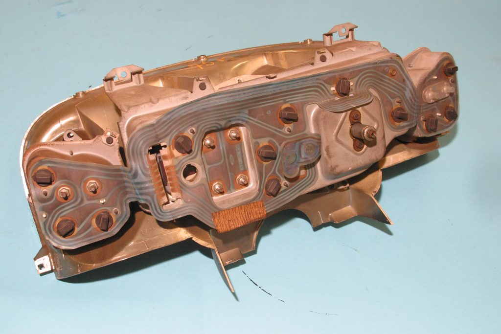 back of a vintage vehicle gauge cluster with circuit traces