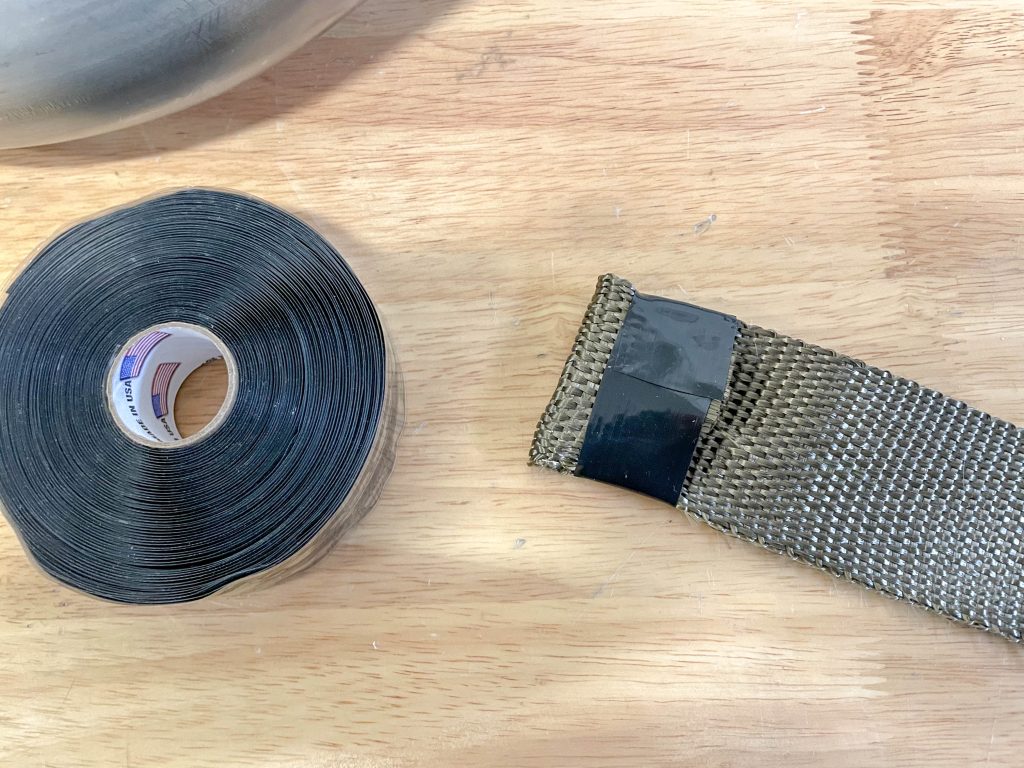 exhaust heat shield end wrapped with electrical tape