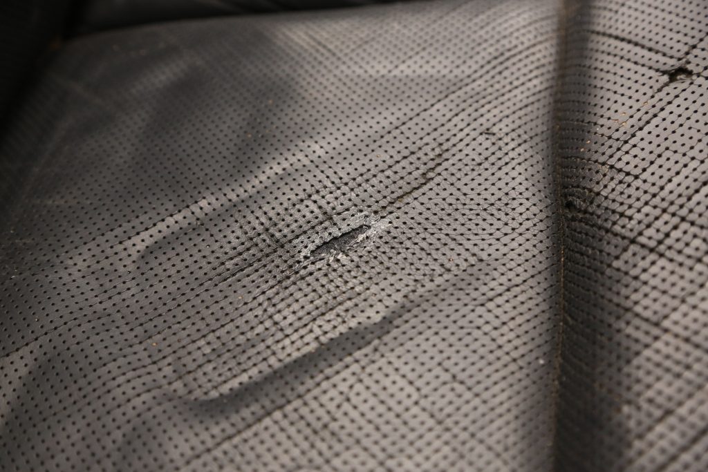 a hole in a vintage car seat