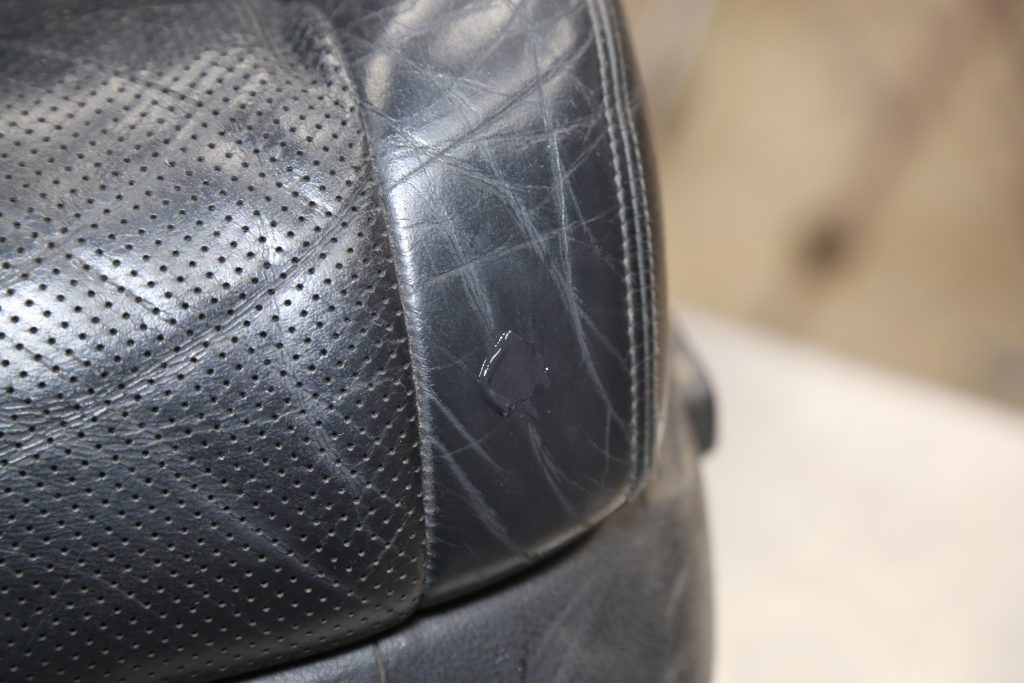 a glued hole in a vintage car seat