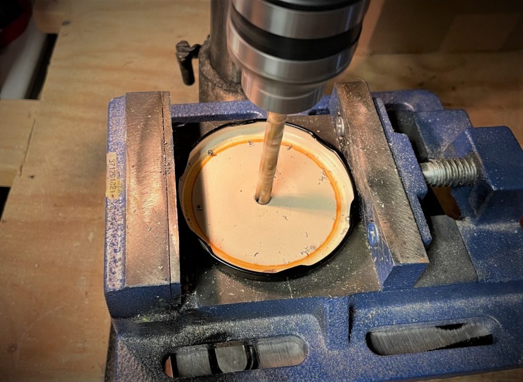 drilling a hole through salsa jar lid
