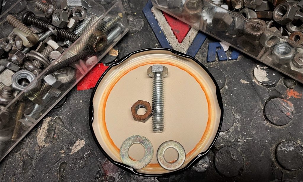 selection of used nuts and bolts on workbench