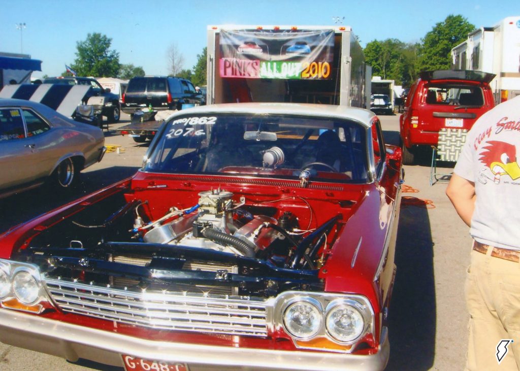 1962 chevy impala drag car in pits at a dragstrip