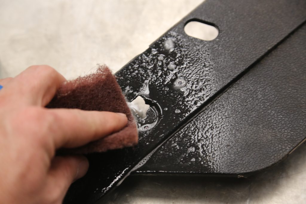 scuffing a piece of plastic trim with a scotch brite