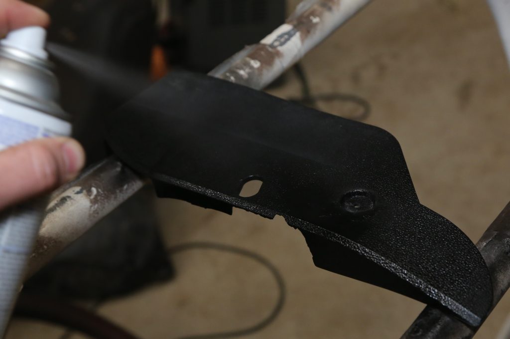 spray painting a repaired automotive interior trim panel