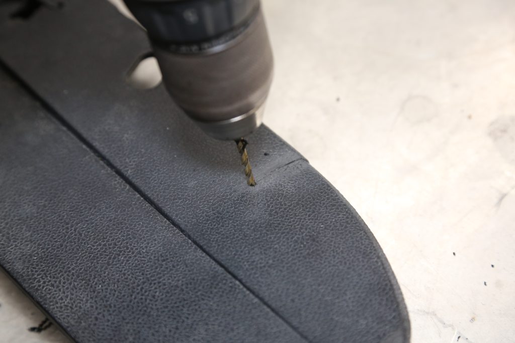 drilling a hole in a plastic automotive panel